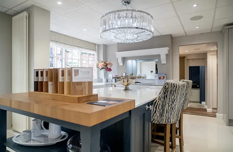Harrogate kitchen showroom interior with island display, oak worktops and a crystal pendant light.