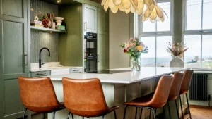 sage green shaker kitchen with flowers
