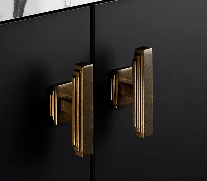 Statement antique brass handles on dark contemporary kitchen cabinetry